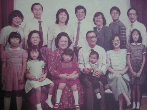 Tricia as a child, in red dress, with relatives