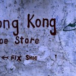 Advertisement for a shoe store on an old wall in George Town.