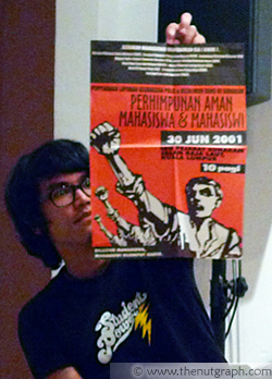 Fahmi Reza holding up a UBU poster 