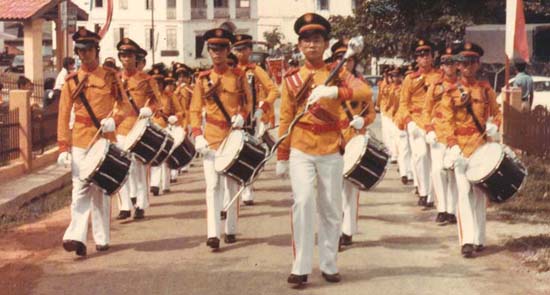 Leading the brass band as a drum major when he was studying in secondary school in Jasin. 