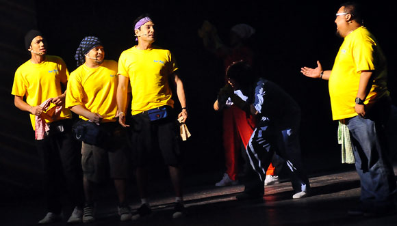 In their signature yellow T-shirts in Cuci the Musical, from left, actors Nabil, Awie, Isaac and Afdlin Shauki