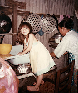 A five-year-old Aishah helping with the dishes in her grandfather’s house in Ipoh